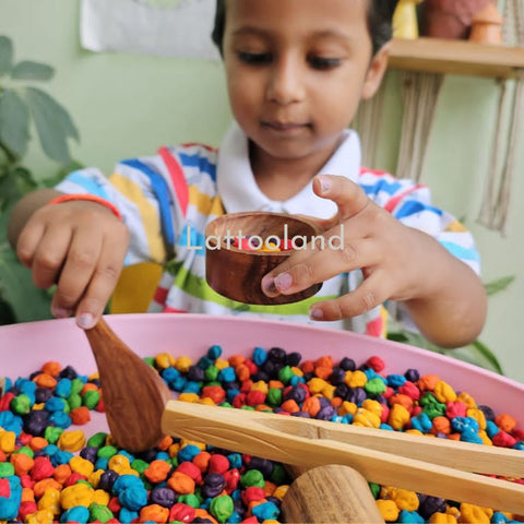  A bin filled with vibrant colored chickpeas, ideal for sensory exploration and creative play.coloured chickpeas for sensory bins