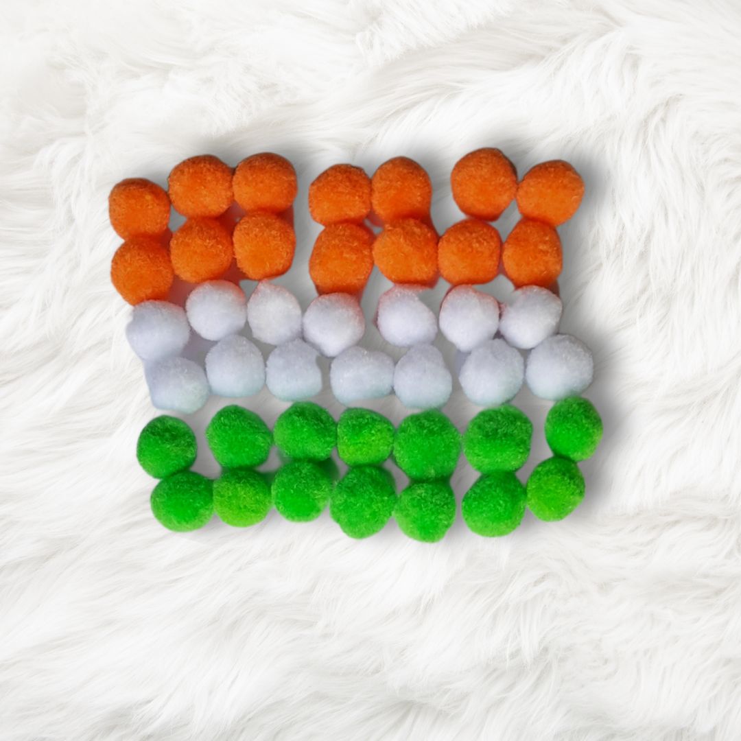 Cultural sensory bin for kids featuring Indian-themed elements for imaginative play. Pompoms for kids for play in India tricolor saffron white green