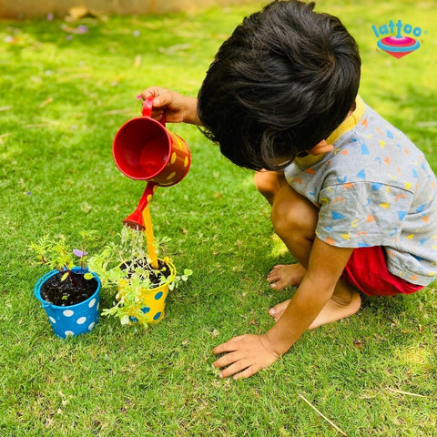 A kid watering the plant with Lattoo's Gardening Kit. Educational gardening tools for kids to learn about nature and responsibility.