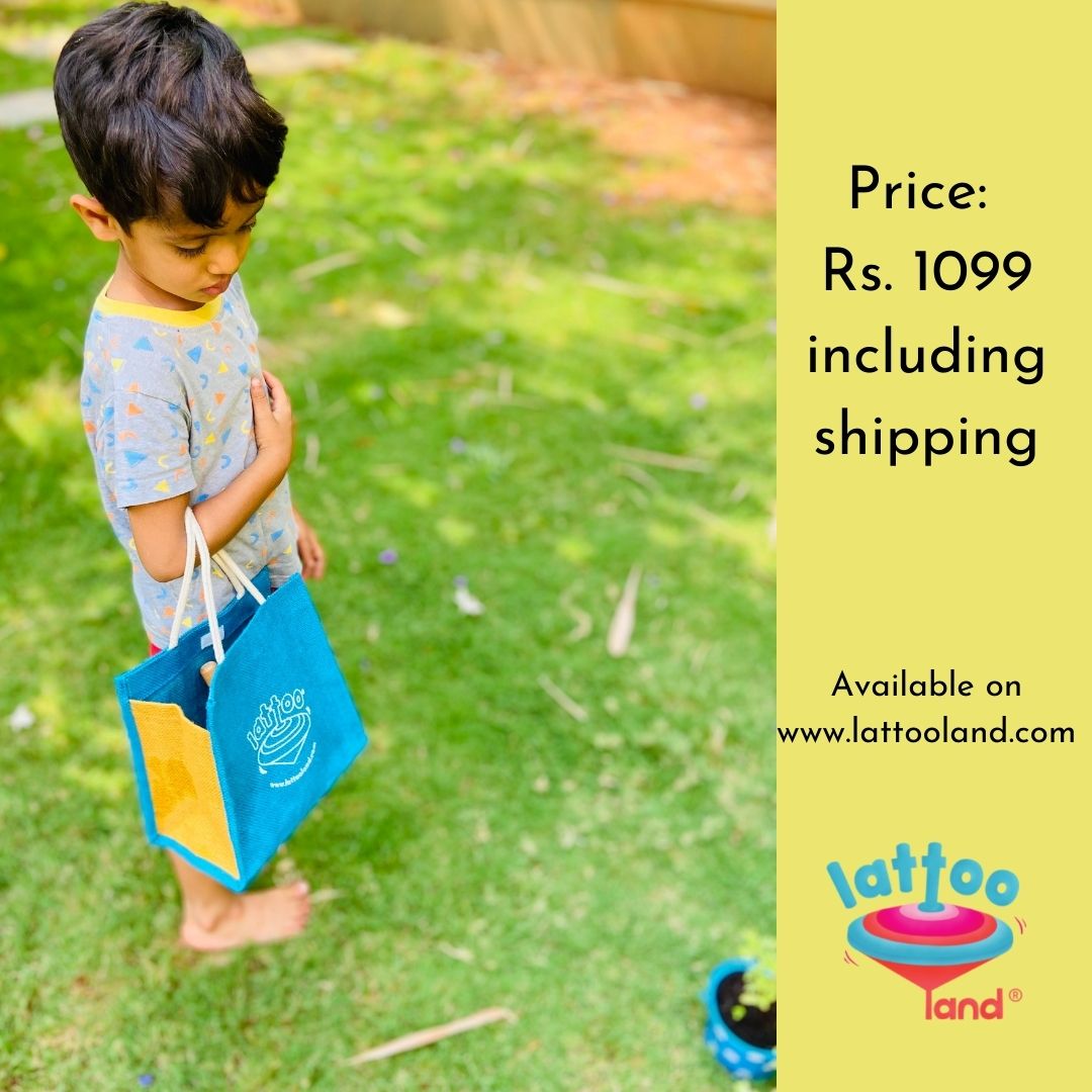 A small boy carrying gardening kit in a jute bag .Mini gardening tools designed for children to inspire a love for gardening and nature.